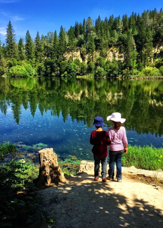 Boy and girl standing by a lake in a forest - friendship card - Photo by Donna Greene